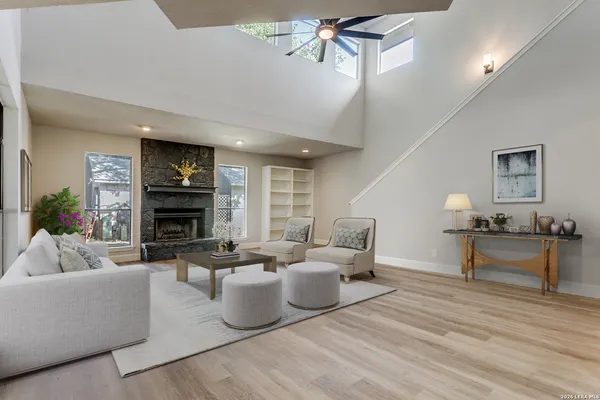 a living room with furniture a fireplace and a potted plant