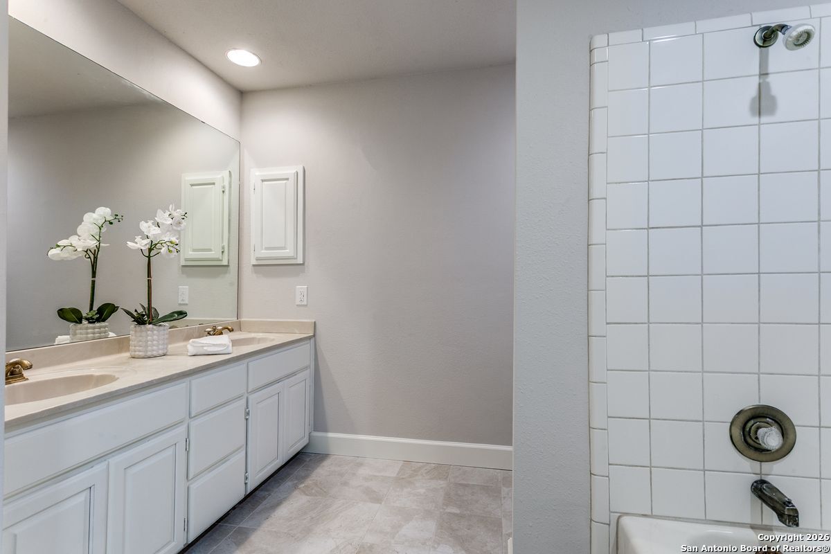 9380 Braun Road, Unit 501B San Antonio, TX 78254 - Photo 23 of 29 a bathroom with a double vanity sink and a mirror