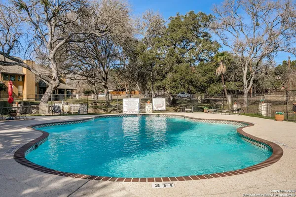 a view of a swimming pool with an outdoor seating