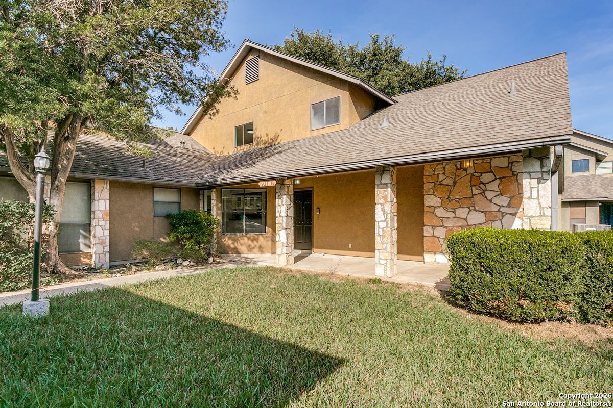 9380 Braun Road, Unit 501B San Antonio, TX 78254 - Photo 6 of 29 a front view of a house with a yard and potted plants