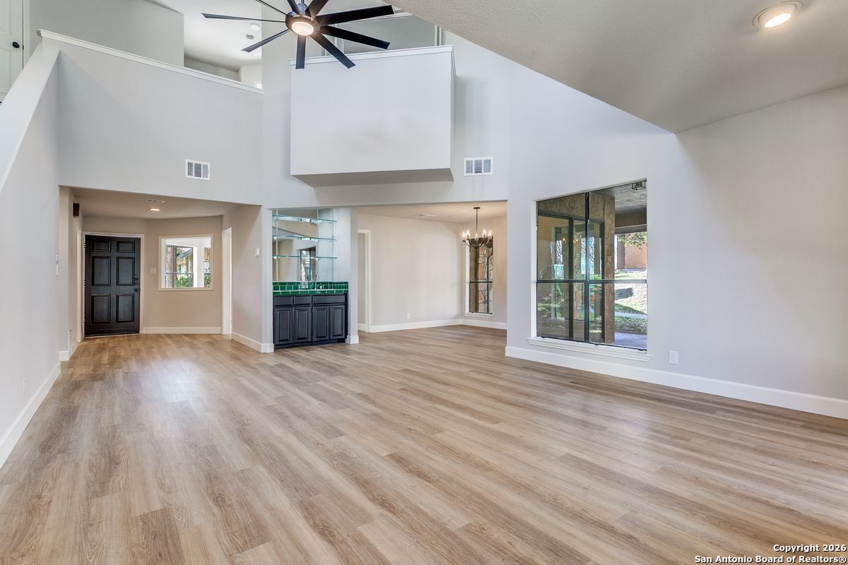 9380 Braun Road, Unit 501B San Antonio, TX 78254 - Photo 8 of 29 a view of an empty room with a window and wooden floor