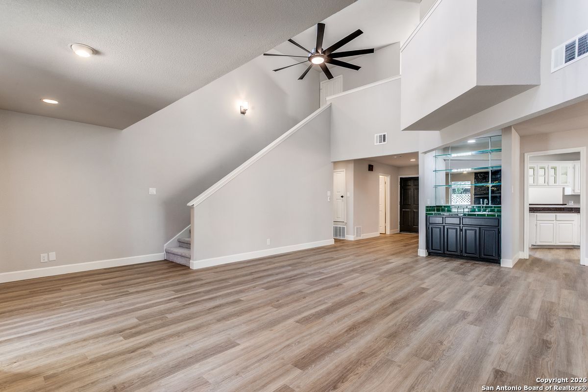 9380 Braun Road, Unit 501B San Antonio, TX 78254 - Photo 9 of 29 a view of empty room with wooden floor and kitchen view