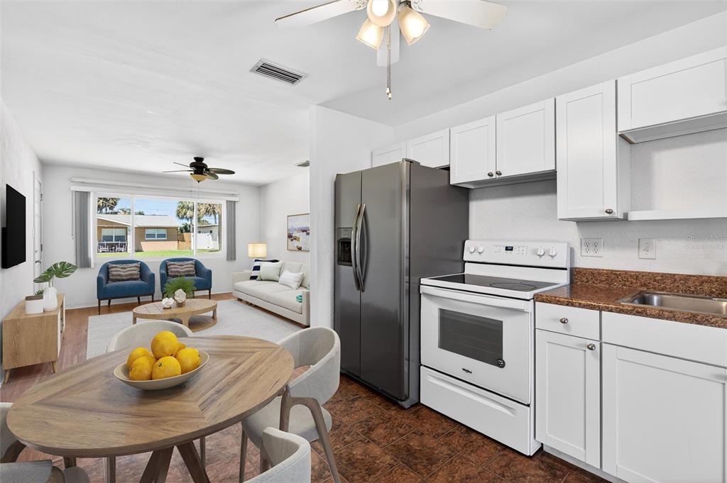 47 Carol Road Ormond Beach, FL 32176 - Photo 5 of 54 a kitchen with stainless steel appliances a white table and chairs
