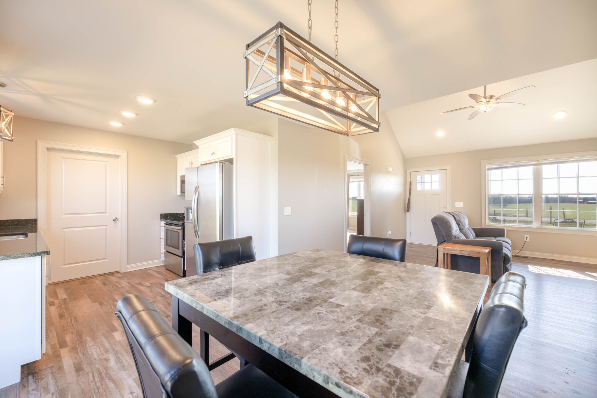 950 White Road Portland, TN 37148 - Photo 16 of 35 a view of a dining room and livingroom with furniture wooden floor a chandelier
