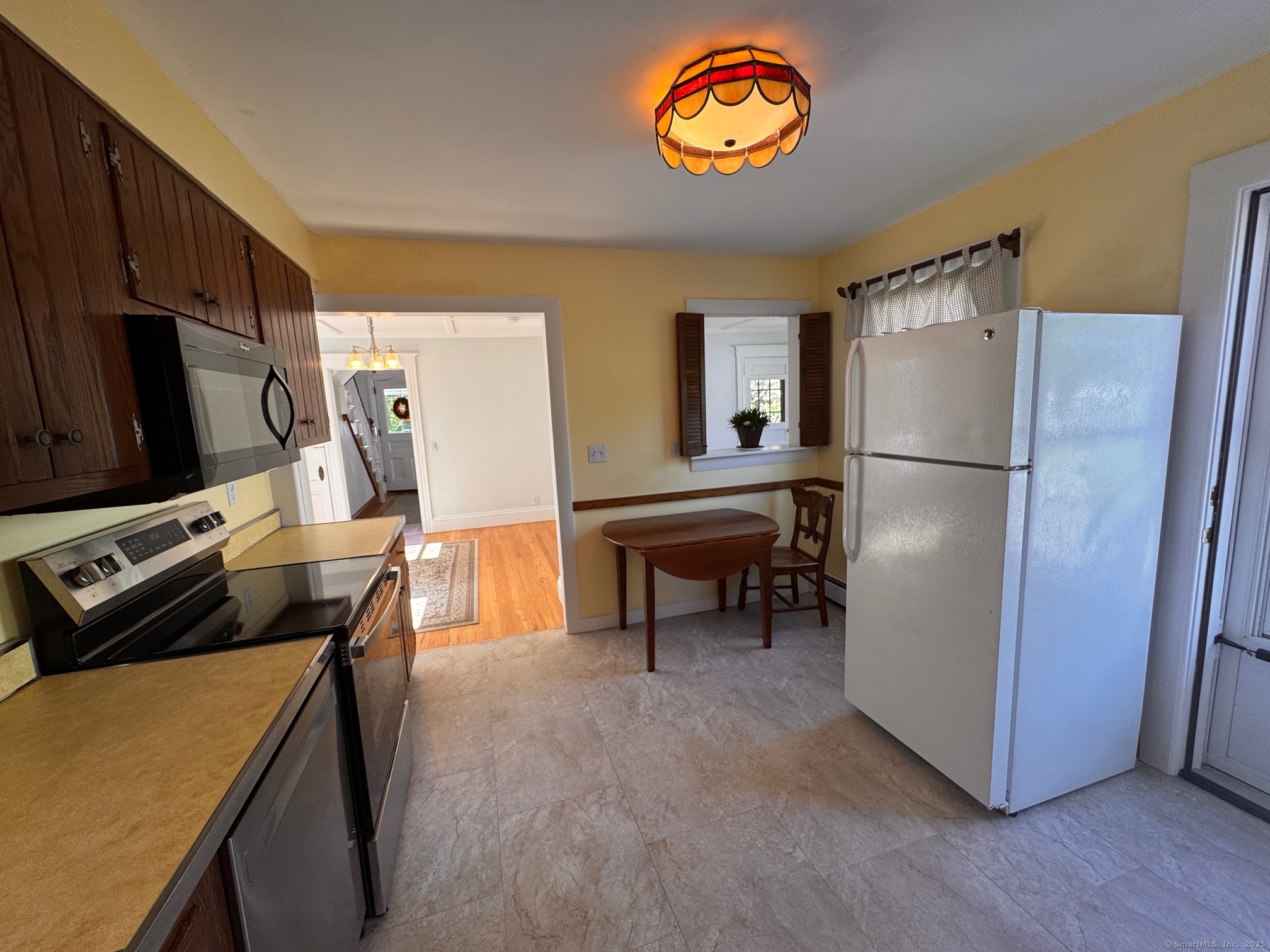 17 High Street Groton, CT 06340 - Photo 22 of 37 a kitchen with a refrigerator and a stove top oven