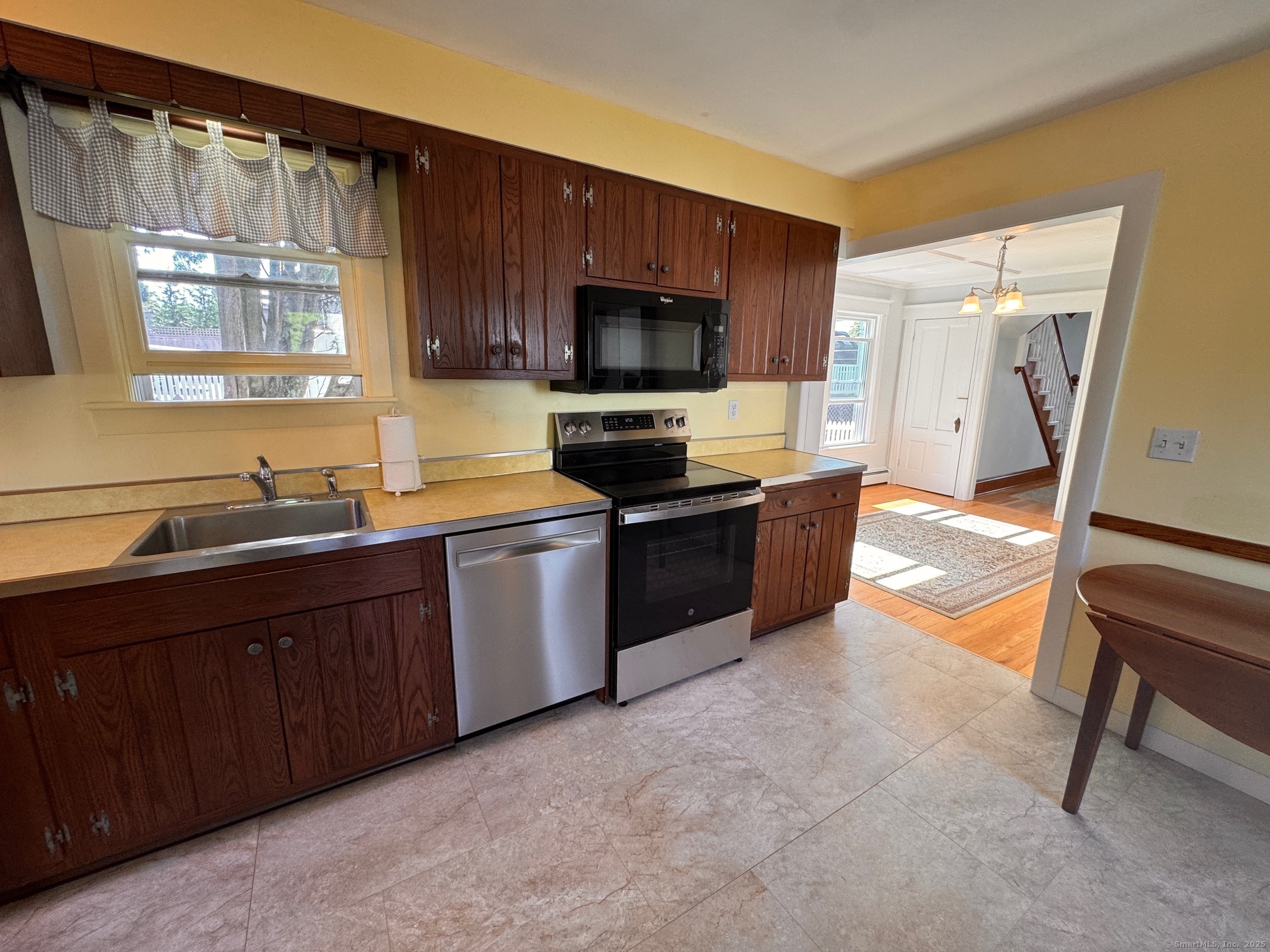 17 High Street Groton, CT 06340 - Photo 23 of 37 a kitchen with stainless steel appliances granite countertop a stove a sink and a microwave