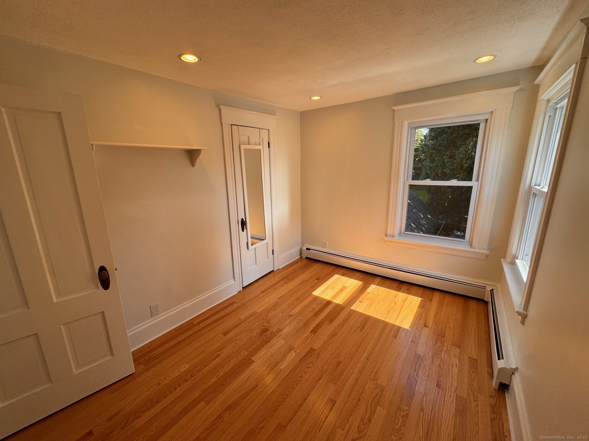 17 High Street Groton, CT 06340 - Photo 32 of 37 a view of an empty room with wooden floor and a window