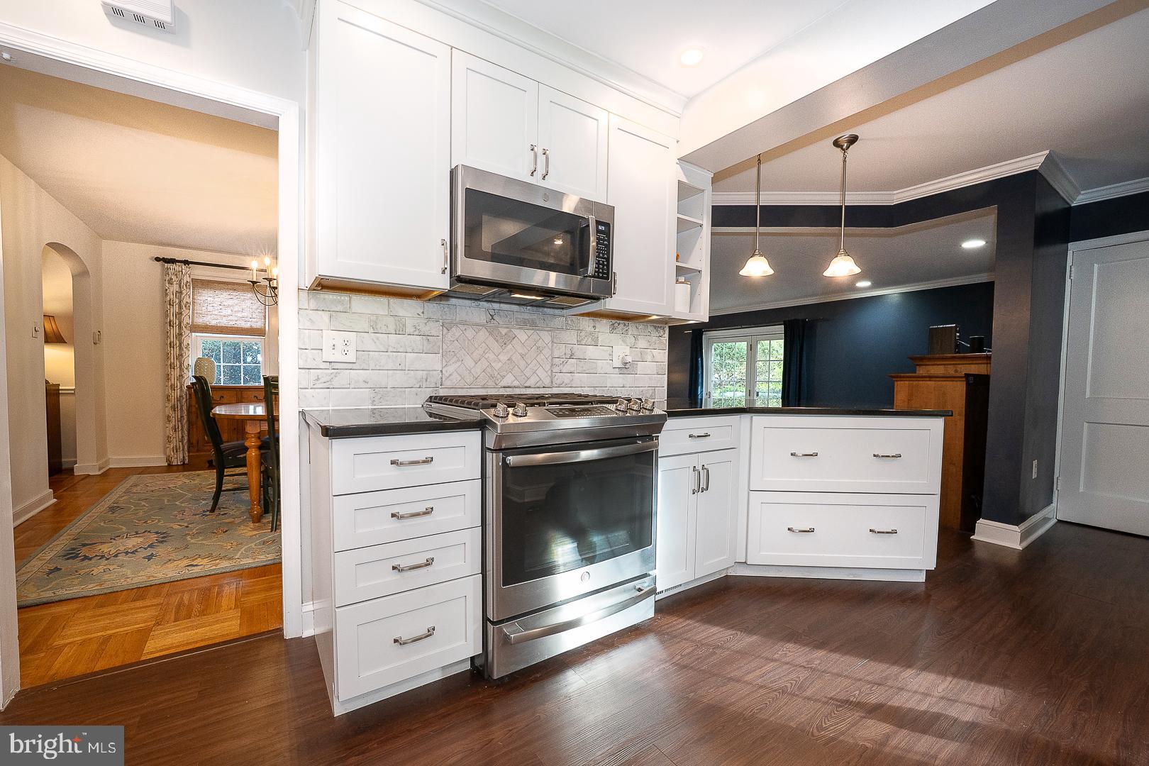 802 Pleasant Hill Road Wallingford, PA 19086 - Photo 16 of 44 a kitchen with stainless steel appliances kitchen island granite countertop a stove and a sink