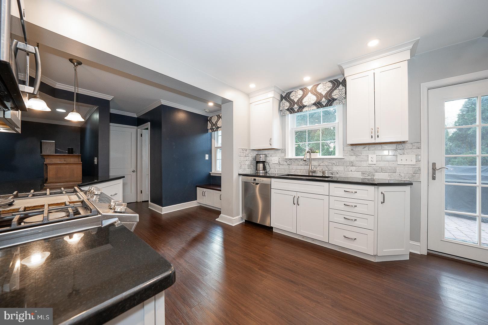 802 Pleasant Hill Road Wallingford, PA 19086 - Photo 20 of 44 a kitchen with a table chairs sink and cabinets