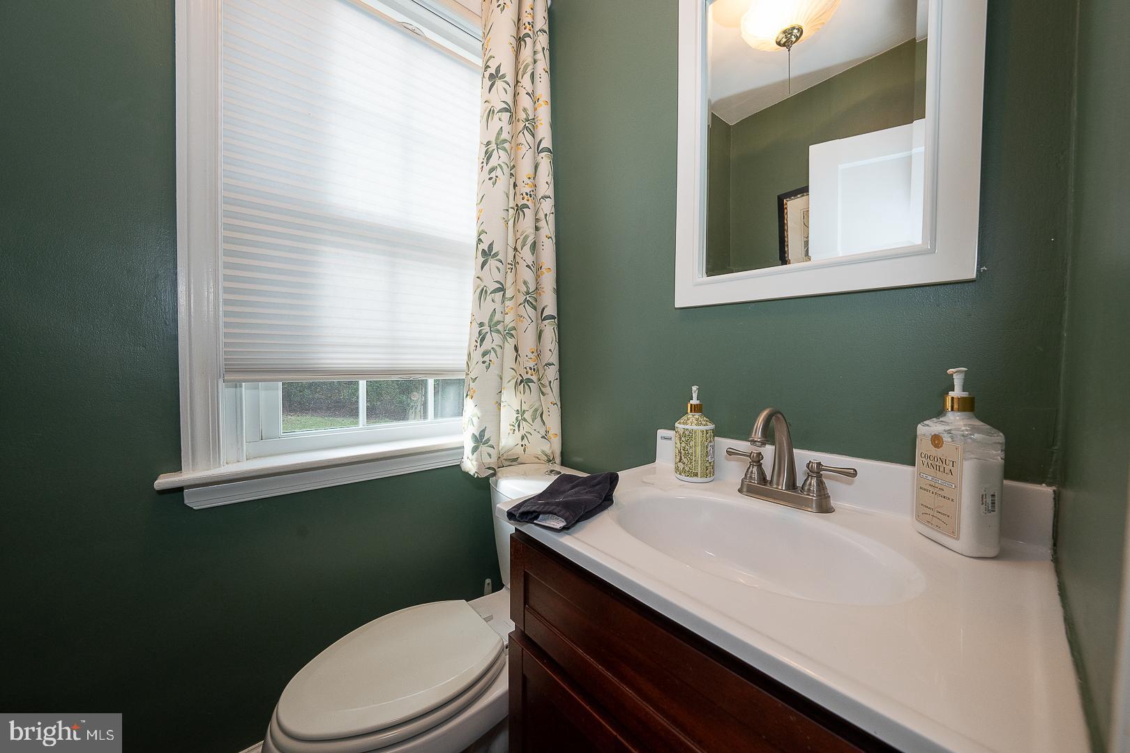 802 Pleasant Hill Road Wallingford, PA 19086 - Photo 22 of 44 a bathroom with a sink vanity mirror and toilet