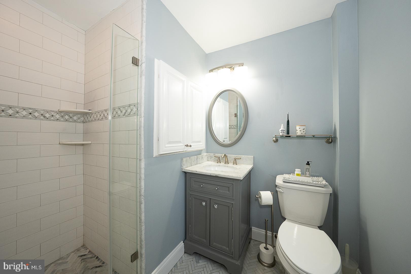 802 Pleasant Hill Road Wallingford, PA 19086 - Photo 26 of 44 a bathroom with a toilet a sink and mirror