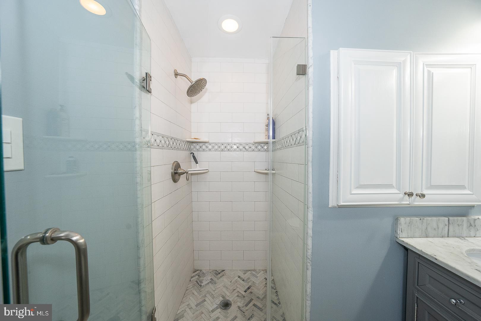 802 Pleasant Hill Road Wallingford, PA 19086 - Photo 27 of 44 a bathroom with a granite countertop sink a mirror and shower