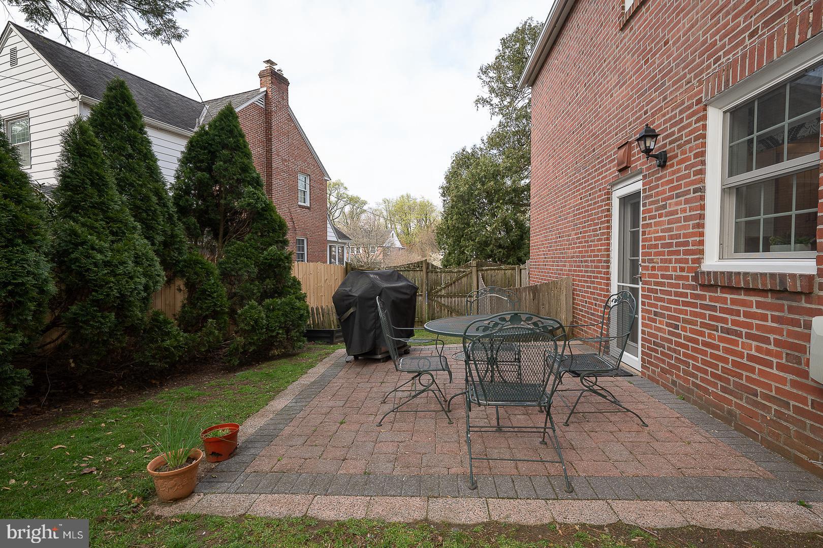 802 Pleasant Hill Road Wallingford, PA 19086 - Photo 42 of 44 a view of a patio with table and chairs and potted plants
