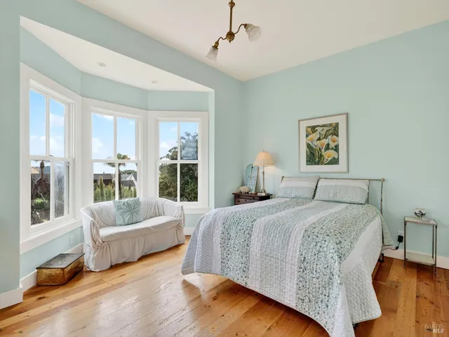 a bedroom with a bed and a chair in it