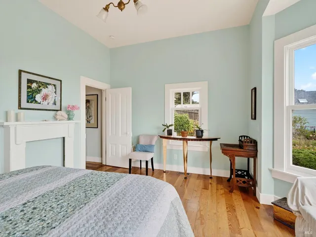 a kitchen with stainless steel appliances granite countertop a table chairs sink and cabinets