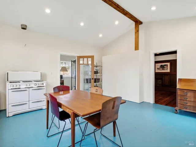 a view of a dining room with furniture and window