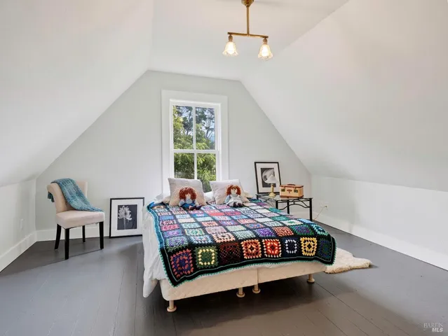 a hallway with a book shelf and wooden floor