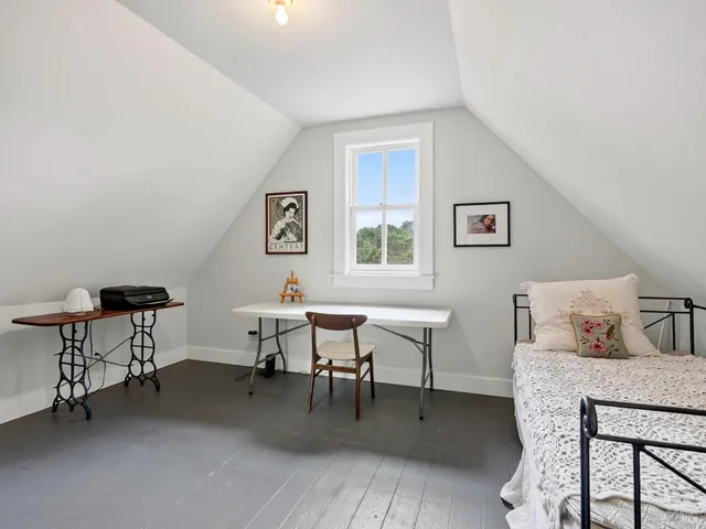 a view of a chair and tables in the balcony