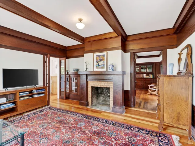 a living room with fireplace furniture and a flat screen tv