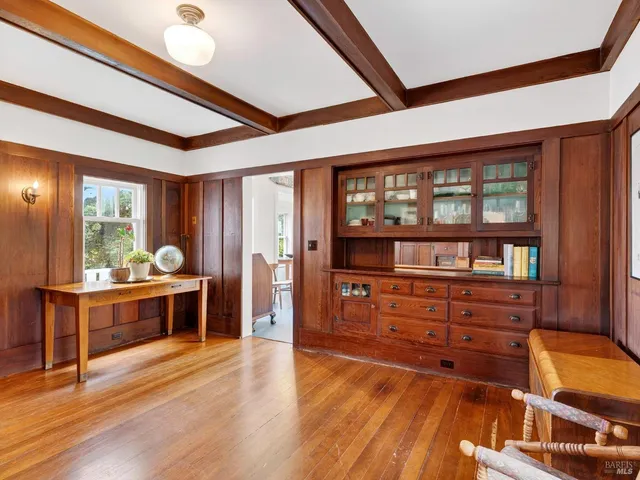 a room with wooden floors and wooden cabinets