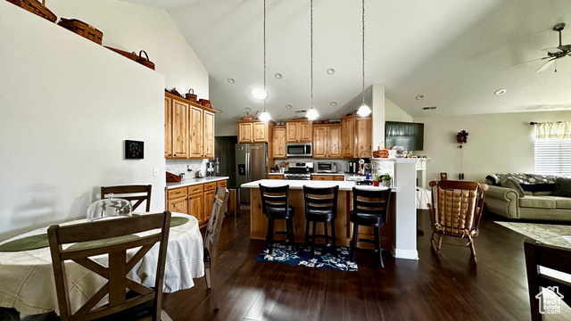 929 West 1920 South, Unit A Syracuse, UT 84075 - Photo 20 of 26 Kitchen with backsplash, stainless steel appliances, dark hardwood / wood-style floors, a kitchen breakfast bar, and decorative light fixtures
