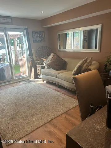 a living room with furniture and large windows