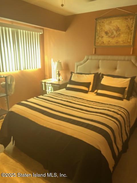 45 Daffodil Court Staten Island, NY 10312 - Photo 28 of 37 a bedroom with a bed and wooden floor