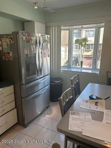 a kitchen with a refrigerator and windows