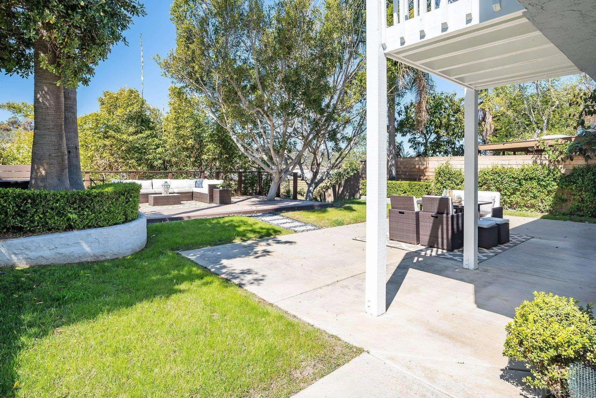 1414 Flair Encinitas Drive Encinitas, CA 92024 - Photo 21 of 41 a view of a patio with table and chairs potted plants and large tree