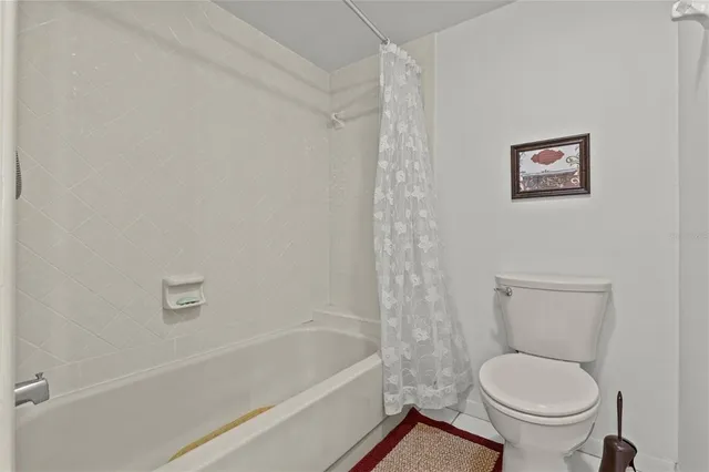 a bathroom with a toilet and a bathtub