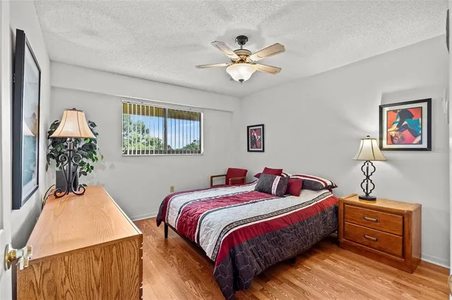 a bedroom with bed and a chandelier