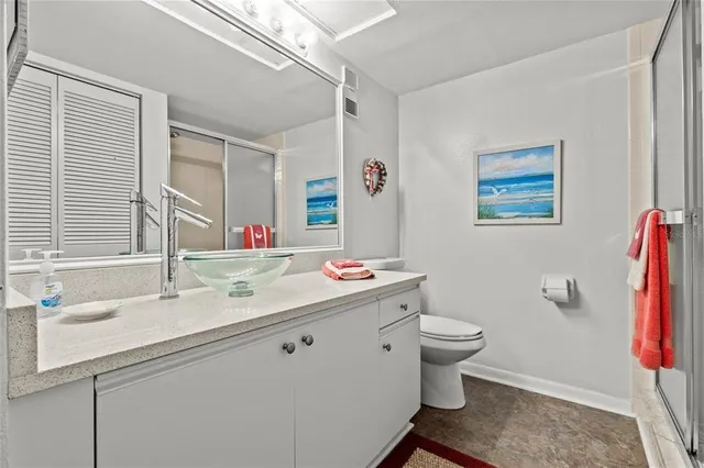 a bathroom with a sink and mirror with toilet