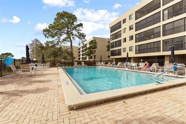 a view of swimming pool with outdoor seating and plants