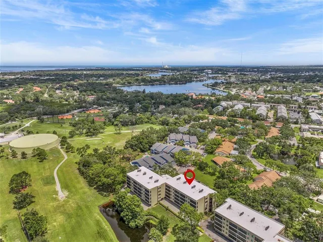 an aerial view of residential houses with city view