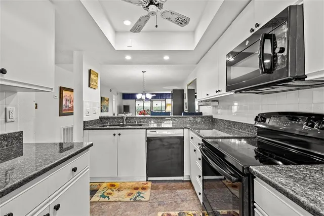 a kitchen with stainless steel appliances granite countertop a stove and a sink