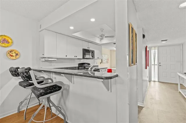 a kitchen with a refrigerator a stove and a cabinets