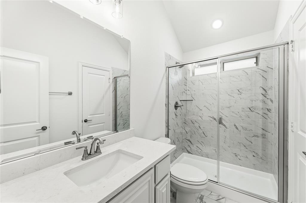 1145 Hitching Post Way Oak Point, TX 75068 - Photo 35 of 39 a bathroom with a sink a toilet and shower