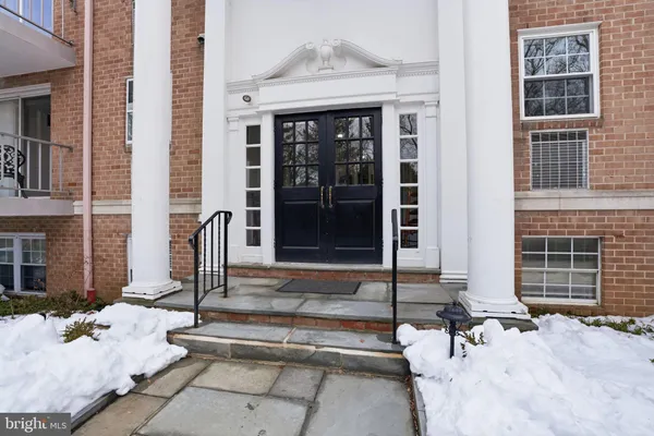 a front view of a building with glass windows and door