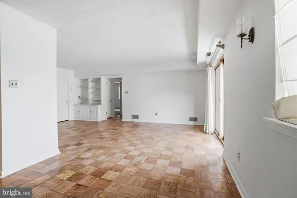 a view of empty room with a fireplace