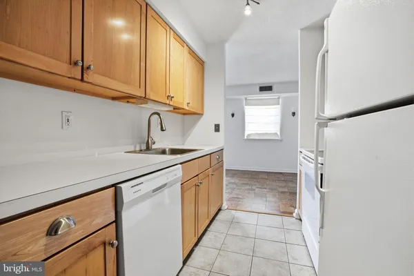 a kitchen with stainless steel appliances granite countertop a sink and dishwasher a stove top oven with white cabinets