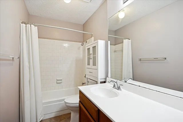 a bathroom with a sink vanity tub and shower