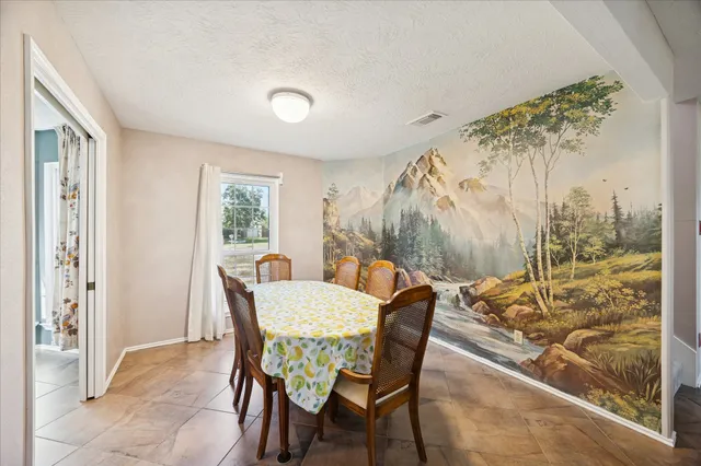 a view of a dining room with furniture window and outside view