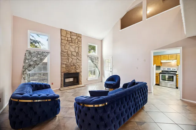 a living room with furniture and a fireplace