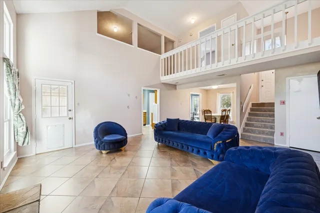 a living room with furniture and a ceiling fan