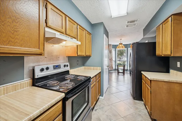a kitchen with a stove and a refrigerator