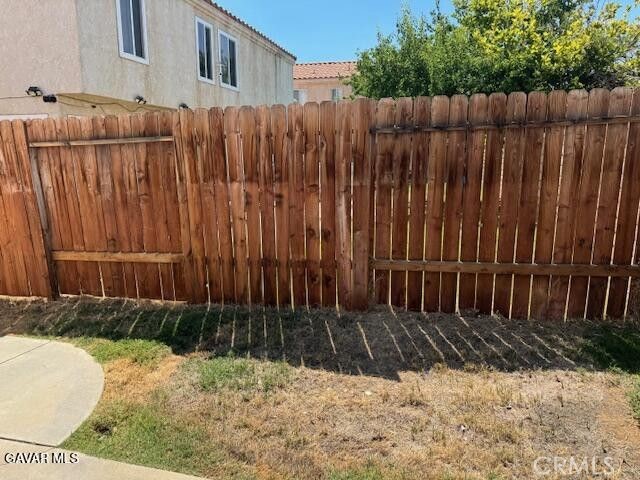 2125 Bramble Lane Palmdale, CA 93550 - Photo 22 of 28 a view of a backyard with wooden fence