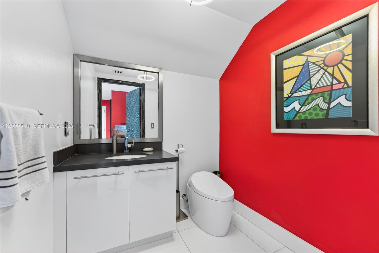 90 Southwest 3rd Street, Unit PH12 Miami, FL 33130 - Photo 16 of 40 a bathroom with a granite countertop toilet sink and mirror