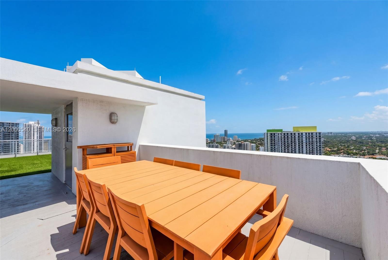 90 Southwest 3rd Street, Unit PH12 Miami, FL 33130 - Photo 9 of 40 a terrace with a table and chairs