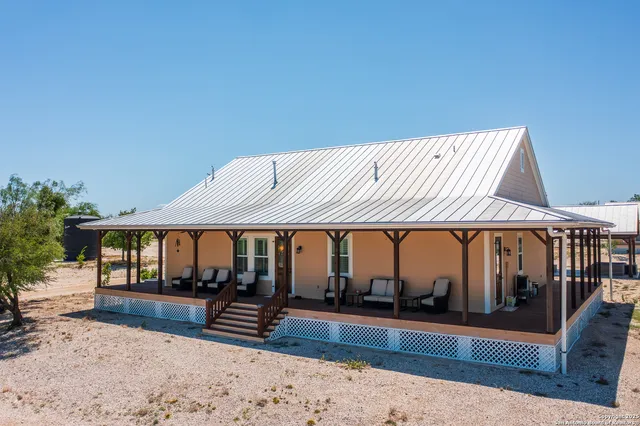 a view of a patio with a table and chairs