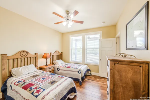 a bedroom with two beds and a window